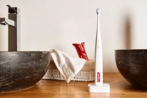 Colgate electric toothbrush on stand